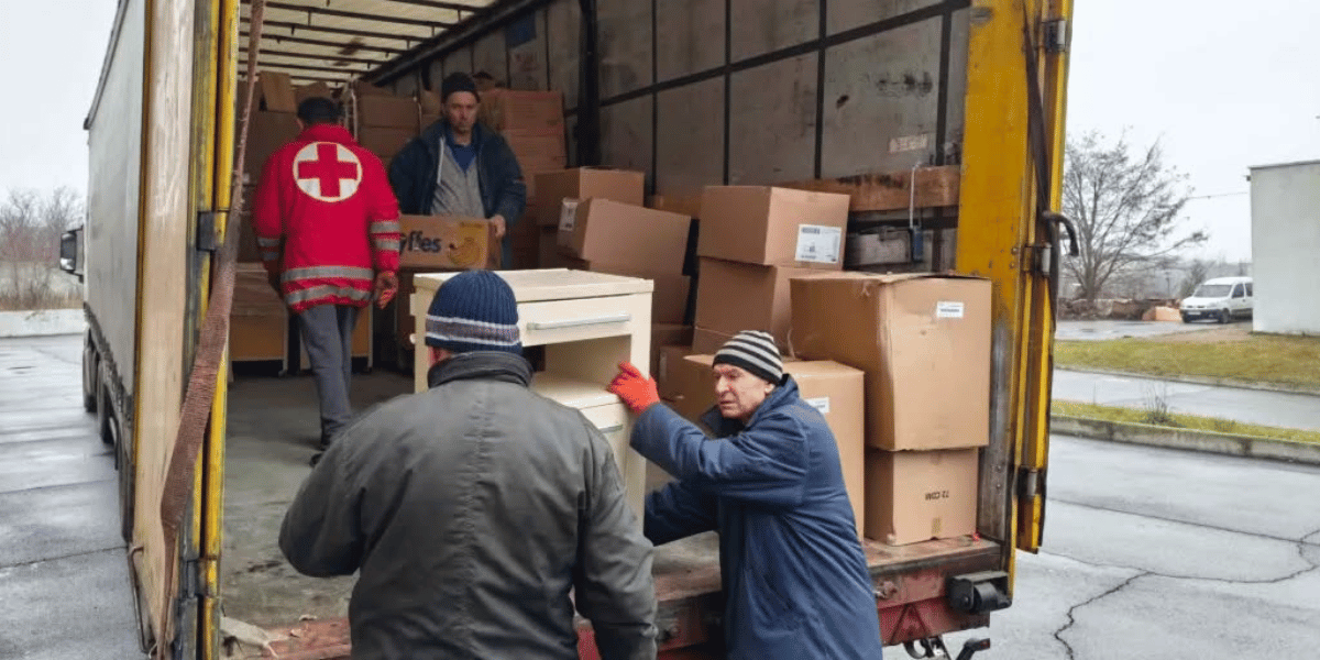 Family of Christ International volunteers unloading truck full of donations