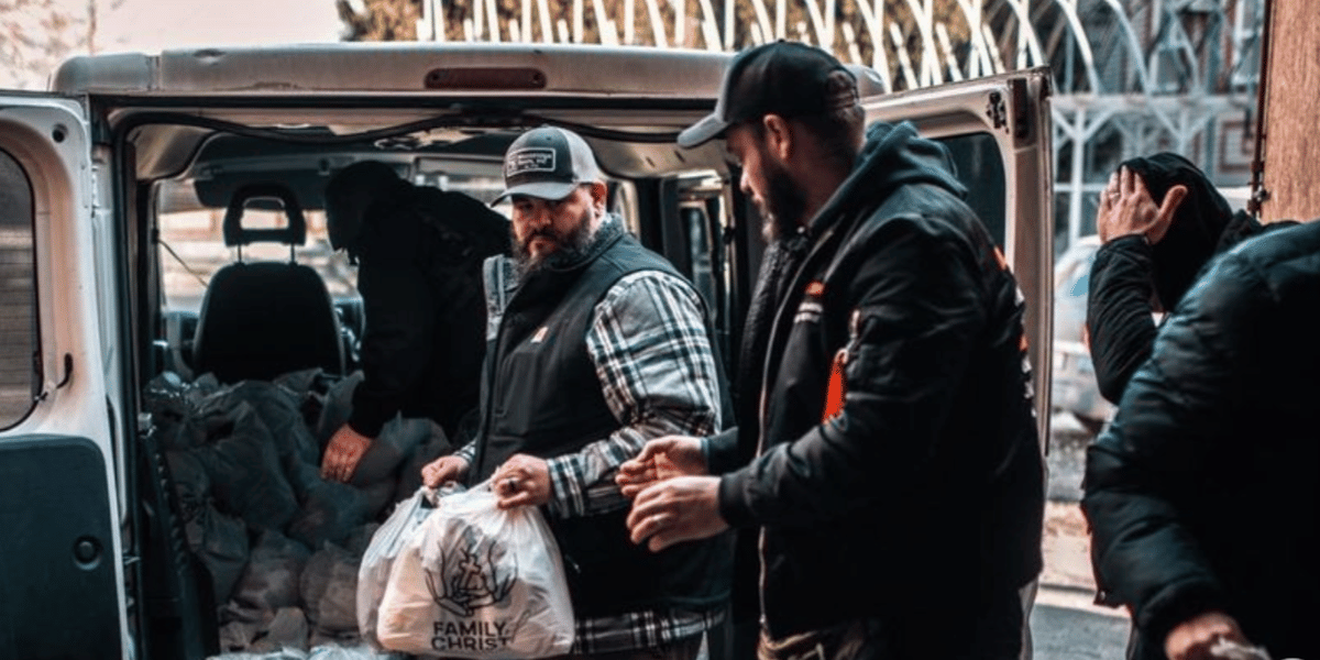 Family of Christ volunteers unloading donations from van in Ukraine