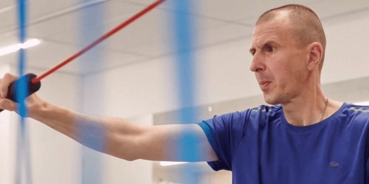 Tara using resistance bands to rehab after losing his arm. 