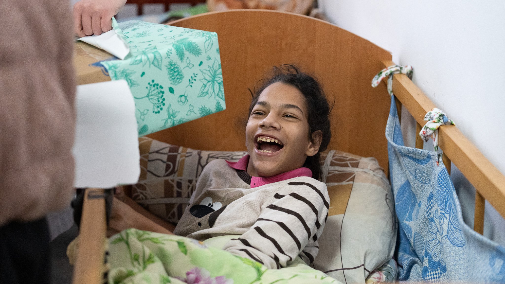 Orphan receiving present from Gift of an Angel | Family of Christ International