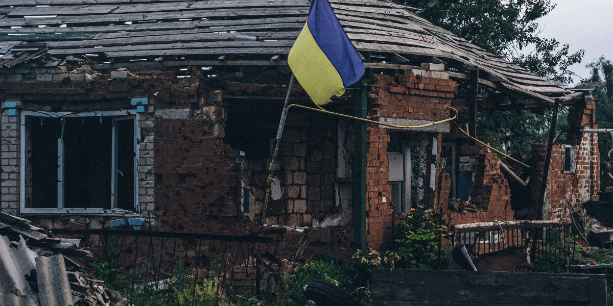 A bombed out house in Ukraine flying a proud Ukrainian flag.