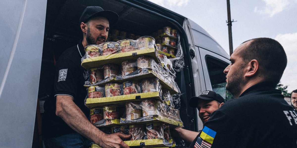 Ukrainian Volunteers Unloading Boxes with Humanitarian Aid